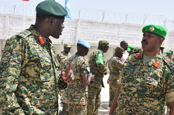 SOMALIA, Mogadishu: In a photograph dated 4 February and released by the African Union-United Nations Information Support team 5 February, Brigadier Paul Lokech, Ugandan Contingent Commander serving with the African Union Mission in Somalia (AMISOM), hands out free mosquito nets to Somali civilians ina compound where Uganan doctors were providing free medical check-ups and treatment in the Kaaran district of the Somali capital Mogadishu. The free medical care and distribution of mosquito nets were part of a week-long programme called Tarehe Sita - Swahili for 6 February - which is the commemorative date that the Ugandan People's Defence Force (UPDF) was formed. This year marks 31 years since the UPDF's creation, which currently has around 6,500 personnel serving with AMISOM in Somalia. AU-UN IST PHOTO / STUART PRICE.